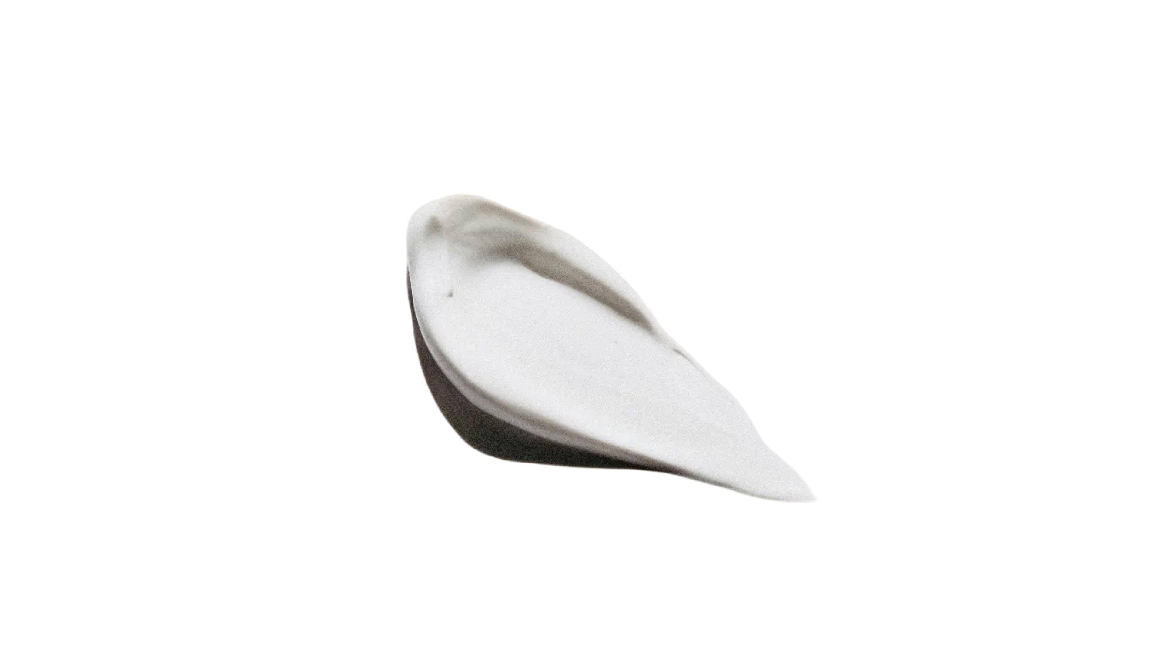 White cream smear on a light gray background